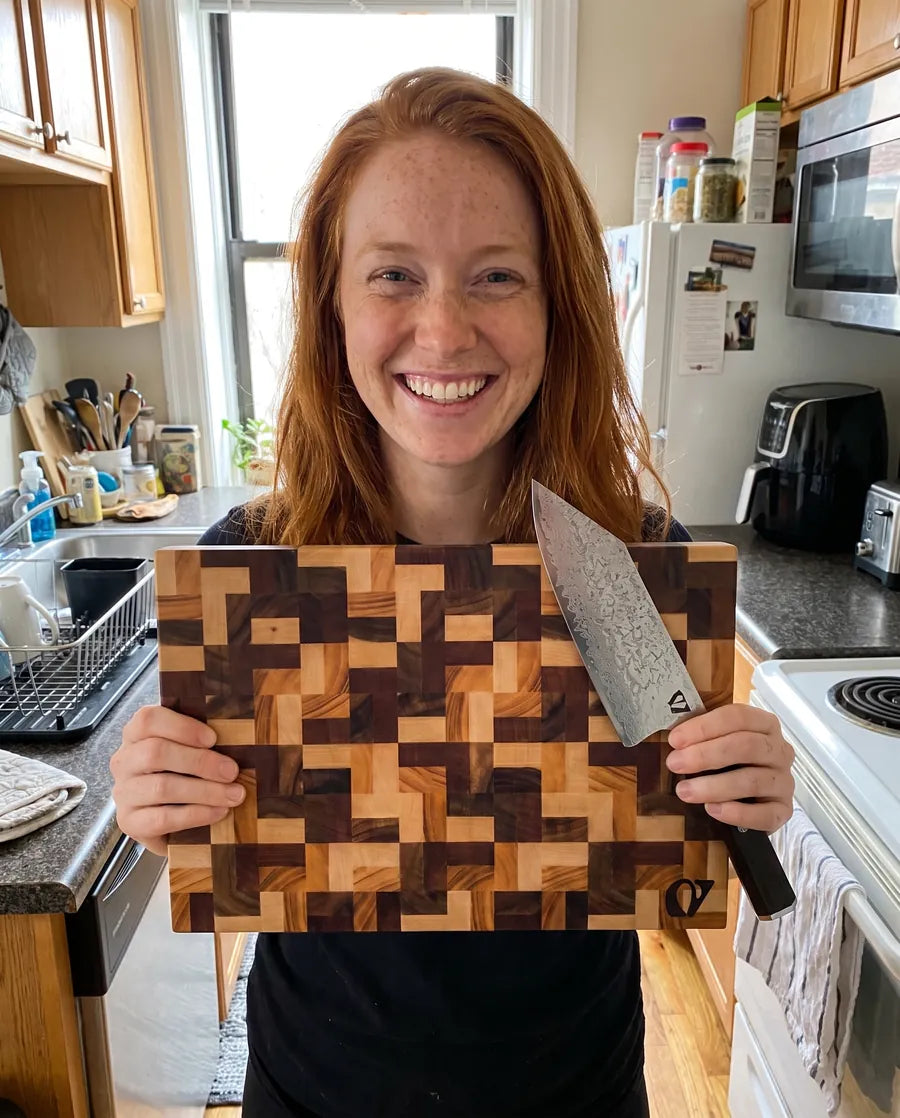 Home cook presenting the Notorious chopping board and chef's knife
