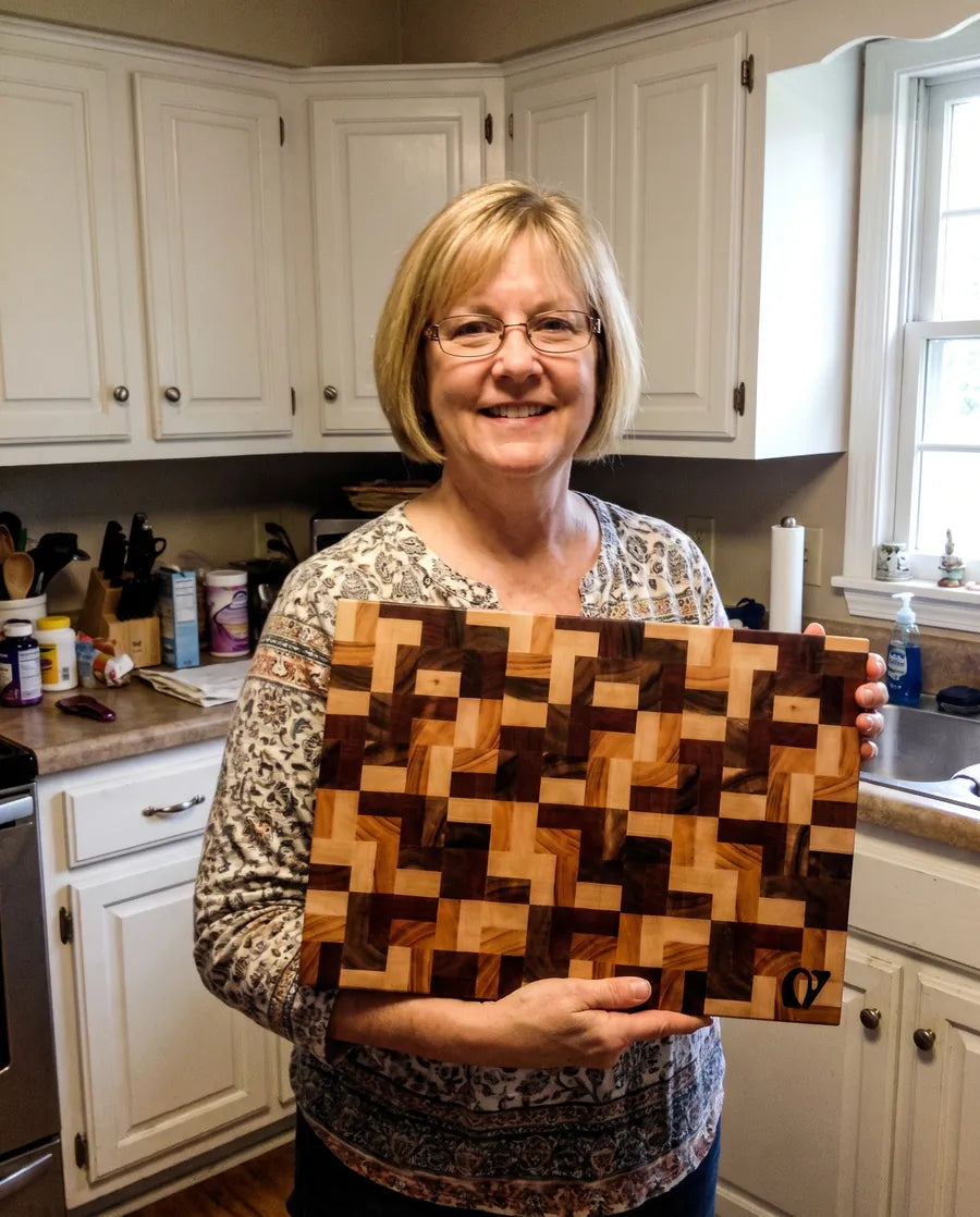 Home cook holding a Notorious end-grain chopping board