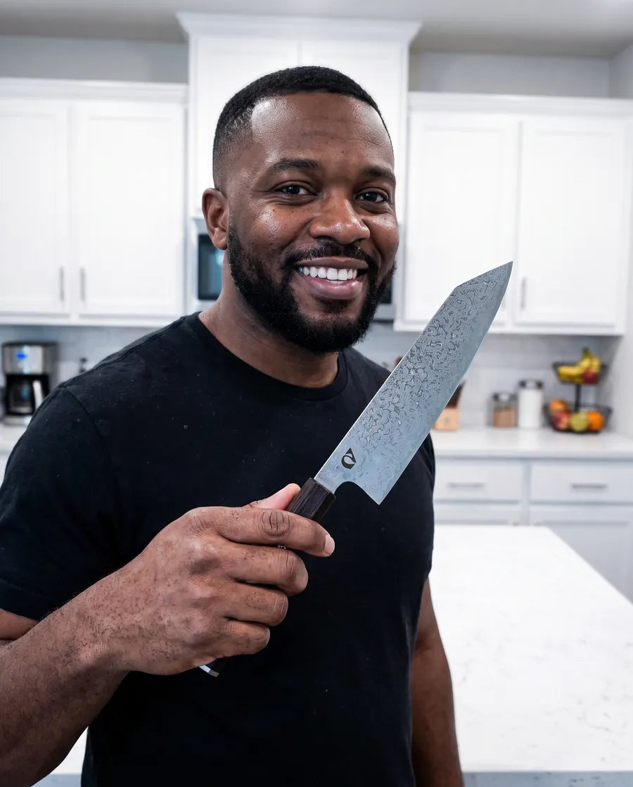 Home cook holding the Notorious Damascus chef's knife