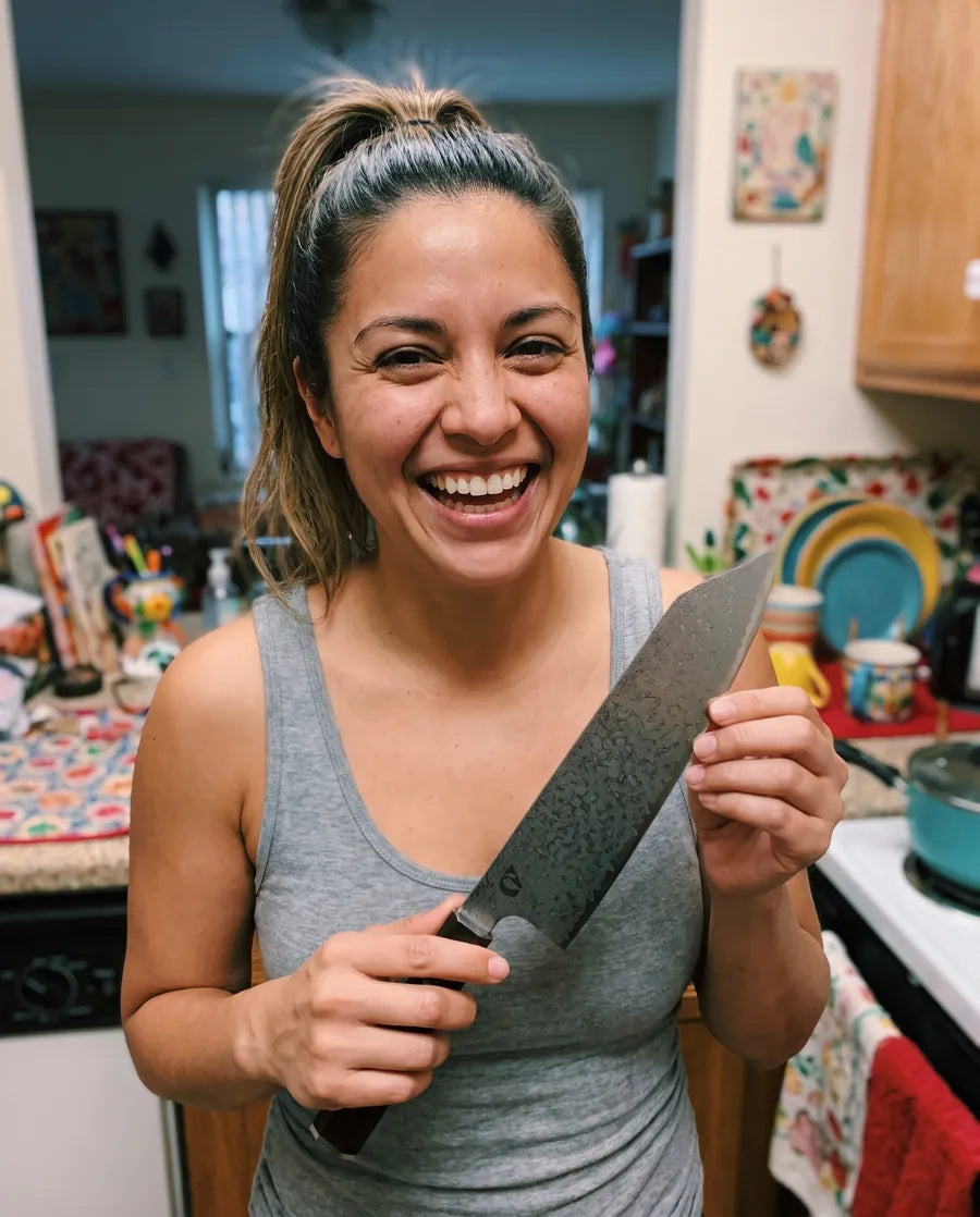 Home cook holding the Notorious Damascus chef's knife