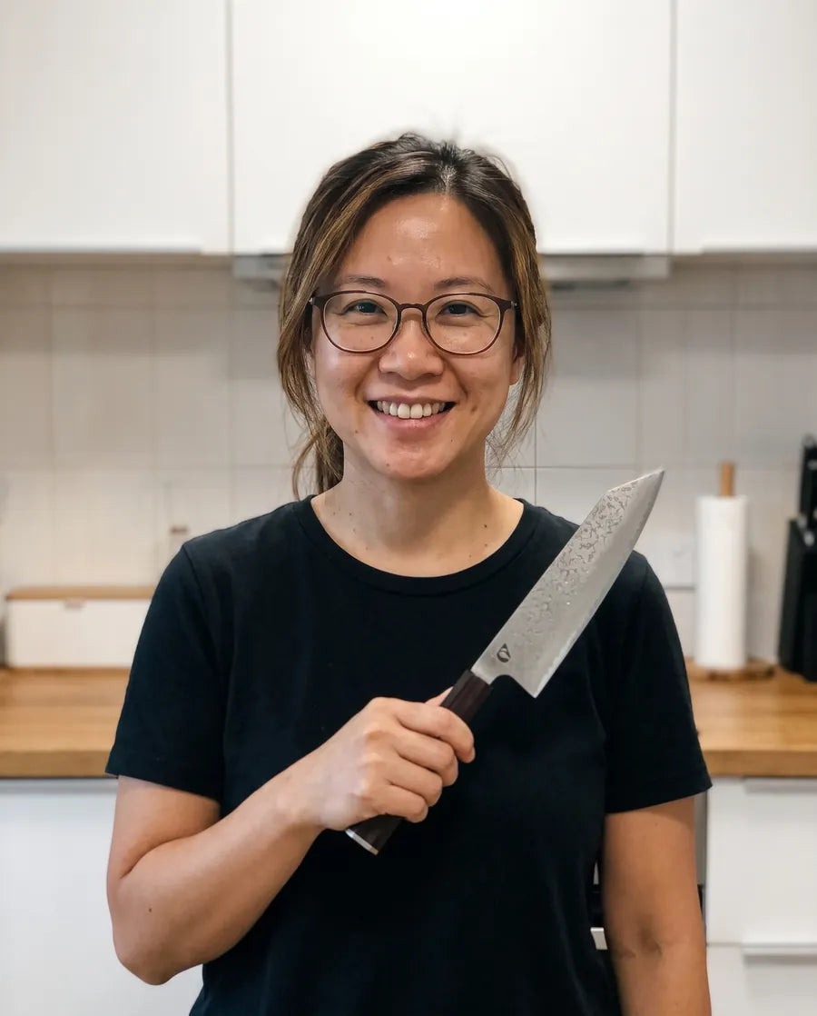 Home cook holding the Notorious Damascus chef's knife